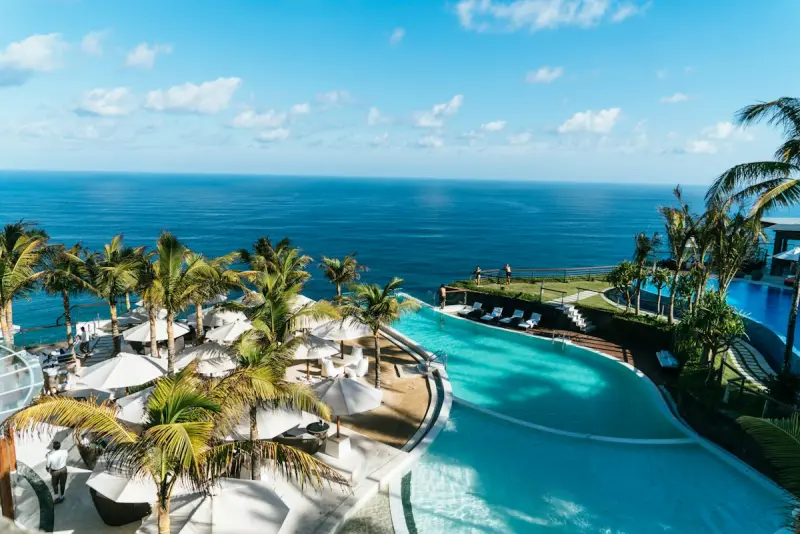 Classic Palm Beach Mediterranean Revival colonnade and manicured oceanfront palms