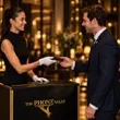 A guest picking up her phone from an attendant